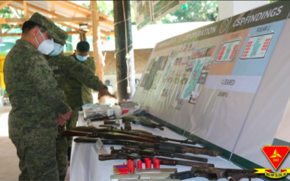<p><strong>COMMAND VISIT.</strong> Army Maj. Gen. Eric Vinoya (left) takes a look at firearms and ammunition recovered from NPA insurgents during his visit on Wednesday (Jan. 6, 2021) to the headquarters of the Joint Enhanced Military and Police Operations Task Force (JEMPO TF) in Negros island. Col. Leonardo Peña, JEMPO TF head and commander of the 302nd Brigade in Negros Oriental, apprised Vinoya of their accomplishments.<em> (Photo courtesy of Philippine Army)</em></p>