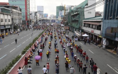 <p><strong>DEVOTION</strong>. Thousands of devotees observe physical distancing as they flock to the Quiapo Church for the annual feast of the Black Nazarene on Saturday (Jan. 9, 2021). Authorities said nearly 300,000 attended Masses in Quiapo Church, Sta. Cruz Church, and San Sebastián Church. <em>(Photo by Avito Dalan)</em></p>