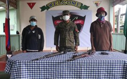 <p><strong>SURRENDERED.</strong> Two Abu Sayyaf Group members surrender to Col. Domingo Gobway (center), commander of the Joint Task Force Basilan, at the headquarters of the 101st Infantry Brigade in Barangay Tabiawan, Isabela City, Basilan on Monday (Jan. 11, 2021), turning over two high-powered rifles. The two were followers of the late Isnilon Hapilon, the self-declared 'emir of the Islamic State in the Philippines.' <em>(Photo courtesy of Joint Task Force Basilan)</em></p>