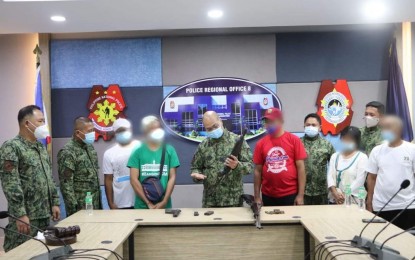 <p><strong>NEW LIFE</strong>. Five former rebels turn over firearms and several live ammunitions to Police Regional Office (PRO) 8 (Eastern Visayas) director, Brig. Gen. Ronaldo de Jesus (center), in Palo, Leyte on Tuesday (Jan. 12, 2021). De Jesus said the returnees also received cash assistance and could avail of benefits under the Enhanced Comprehensive Local Integration Program or E-CLIP. <em>(Photo courtesy of PRO-8)</em></p>
