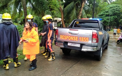 <p><strong>DISASTER RESPONSE.</strong> Rescue teams assist residents affected by the flash flood in some villages in Mambajao town, Camiguin province on Tuesday afternoon (Jan. 12, 2021). Parts of Camiguin and Lanao del Norte were affected by flash floods brought by continuous rains due to a low-pressure area.<em> (Photo courtesy of the Mambajao Municipal Police Station)</em></p>