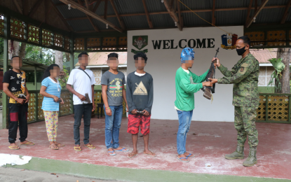 <p><strong>SURRENDER.</strong> One of the six New People's Army surrenderers hands over his firearm to a military officer at the Army’s 37th Infantry Battalion in Lebak, Sultan Kudarat, on Monday (Jan. 18, 2020). Military officials say the former rebels will be enrolled with the government’s Enhanced Comprehensive Local Integration Program. <em>(Photo courtesy of 37IB)</em></p>