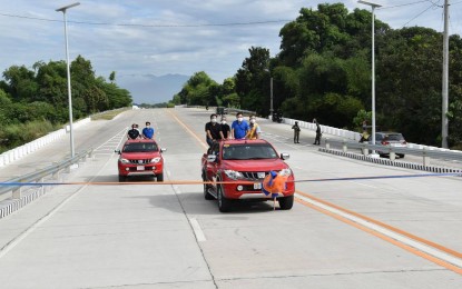 <p><strong>BYPASS ROAD OPENING</strong>. The group of Department of Public Works and Highways headed by Secretary Mark Villar drives through the bypass road in Urdaneta City, Pangasinan during the ceremonial opening on Jan. 18, 2021. The road, crossing two major road intersections of Urdaneta-Dagupan Road and Urdaneta-Manaoag Provincial Road, will benefit about 38,000 motorists daily. <em>(Photo courtesy of DPWH Facebook page)</em></p>