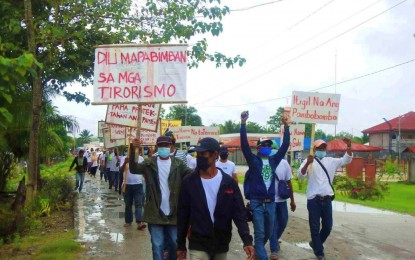 <p><strong>NO TO TERRORISM.</strong> Fed up by the atrocities perpetrated by the Bangsamoro Islamic Freedom Fighters, residents of Rajah Buayan, Maguindanao take to the streets on Tuesday (Jan. 19, 2021) to condemn the terror group’s activities. The town residents vowed to help the government fight the BIFF, which they blamed for instigating recent killings and bombings in the town. <em>(Photo courtesy of 33IB)</em></p>