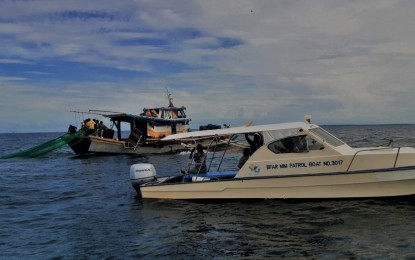 <p><strong>WARNING TO ILLEGAL FISHERS.</strong> The Fishery Resource Protection Group of the Bureau of Fisheries and Aquatic Resources (BFAR) in Central Visayas is seen in this Jan. 17, 2021 photo apprehending an illegal fishing boat operator and his eight crew members from Victorias City, Negros Occidental after they were caught fishing off the municipal waters of Madridejos town in Bantayan Island, north of Cebu. BFAR-7 on Thursday (Jan. 21, 2021) warned illegal fishing operators on their illicit activities in Central Visayas waters as it heightened fishery law enforcement efforts amid the Covid-19 pandemic. <em>(Photo courtesy of BFAR-7)</em></p>