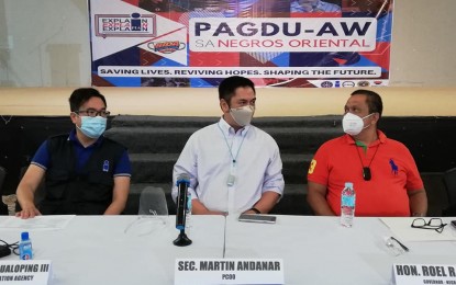 <p><strong>COVID-19 ROADSHOW</strong>.  PCOO Sec. Martin Andanar (center) is flanked by Usec. Ramon Cualoping III, Director General of the Philippine Information Agency; and Negros Oriental Gov. Roel Degamo, during Friday's (Jan. 22, 2021) Pagdu-aw: Explain, Explain, Explain roadshow on the government's Covid-19 vaccine rollout program in Dumaguete City. Degamo announced the allocation of PHP40 million for the vaccine procurement of the provincial government<em>. (Photo by Judy Flores Partlow)</em></p>
