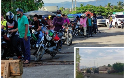<p><strong>STALLED.</strong> Hundreds of motorists are held at the Delta Bridge separating Cotabato City and the town of Sultan Kudarat, Maguindanao Saturday morning (Jan. 23, 2020) following an encounter between members of a heavily-armed lawless group and government forces. Military tanks (inset) are also deployed along the highway in Sultan Kudarat town to prevent a spillover of the incident to Cotabato City. <em>(Photo courtesy of Anne Acosta/Mindanao Expose)</em></p>