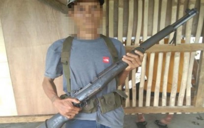 <p><strong>SURRENDER</strong>. Ka Gorio, a mass organizer of the communist New People's Army, stands ready to turn over his firearm to officials of the Army’s 38th Infantry Battalion in Palimbang, Sultan Kudarat before his surrender on Sunday (Jan. 24, 2021). The surrenderer said he just wanted to be with his family once more after being duped into joining the futile communist movement several years ago. <em>(Photo courtesy of 6ID)</em></p>