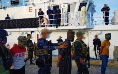 <p><strong>ARRESTED.</strong> Authorities arrest a village official who allegedly has ties with the Abu Sayyaf Group bandits, including three of his companions in a law enforcement operation in Sumisip, Basilan province on Thursday (Jan. 28, 2021). In photo are the arrested suspects as they are being transported from Basilan to the Anti-Kidnapping Group headquarters at Cmp Batalla, Zamboanga City. <em>(Photo courtesy of the Coast Guard District Southwestern Mindanao)</em></p>