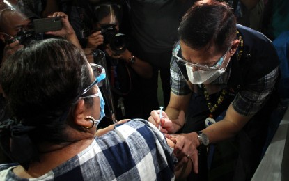 <p><strong>MOCK VACCINATION</strong>. Health Secretary Francisco Duque III administers the "Covid-19 vaccine" to Mayor Menchie Abalos during a vaccination simulation at the Pedro P. Cruz Mandaluyong Elementary School on Friday (Feb. 5, 2021). Duque urged for the swift creation of an indemnification fund law that seeks to compensate individuals who would suffer adverse effects from the Covid-19 vaccines.<em> (PNA photo by Jess M. Escaros Jr.)</em></p>