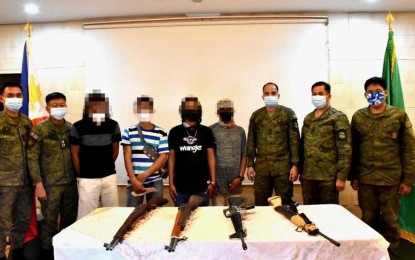<p><strong>BACK INTO THE FOLD.</strong> A total of four Abu Sayyaf Group bandits surrender on Saturday (Feb. 6, 2021) due to disunity and loss of leaders. Photo shows the four ASG surrenderers and the firearms they yielded, together with military officials in Sulu. <em>(Photo courtesy of the 11th Infantry Division Public Information Office)</em></p>