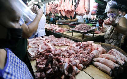 <p><strong>PRICE CAP.</strong> Vendors and consumers alike were protected by the price ceiling law that set a cap on pork prices. The Department of Agriculture also tapped its regional offices to send surplus meat products to the National Capital Region. <em>(PNA file photo)</em></p>