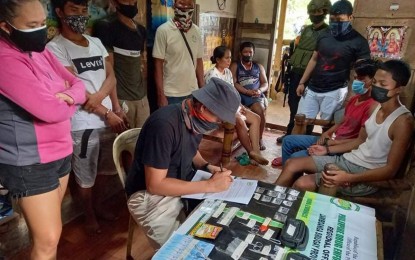 <p><strong>DISMANTLED.</strong> A team of Philippine Drug Enforcement Agency and police officers arrest six people as they dismantle a drug den Friday (Feb. 12, 2021) in Barangay Tenan, Ipil, Zamboanga Sibugay. In photo is a PDEA agent conducting an inventory of the pieces of evidence seized from the suspects. <em>(Photo courtesy of PDEA-9)</em></p>
