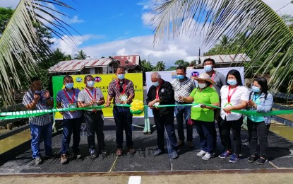 <p><strong>BRIDGE TO PROGRESS.</strong> Regional Director Leomides R. Villareal (5th from left), of the Department of Agrarian Reform in Caraga Region, and DAR Agusan Sur Provincial Officer Jamil P. Amatonding, Jr. (4th from left) lead the opening of the PHP20-million 'Tulay ng Pangulo' in Barangay Panagangan, La Paz town, on Tuesday (Feb. 16, 2021). The bridge would benefit at least 2,177 identified Agrarian Reform Beneficiaries and an estimated 8,084 residents in five barangays in La Paz. <em>(Photo courtesy of DAR-ADS Information Office)</em></p>
