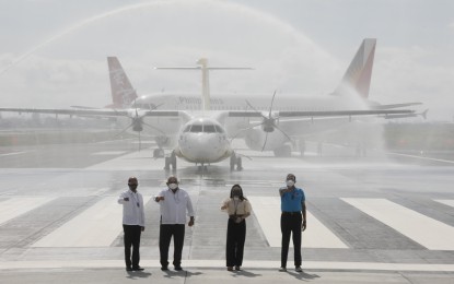 <p><strong>NAIA RUNWAY INAUGURATION. </strong>Defense Secretary Delfin Lorenzana (left), Executive Secretary Salvador Medialdea (2nd from left), Tourism Secretary Bernadette Romulo-Puyat (2nd from right), and Transportation Secretary Arthur Tugade (right), lead the inauguration and commissioning of the repair and overlay of the newly-constructed taxiway of the Terminal 2 of the Ninoy Aquino International Airport in Pasay City on Tuesday (Feb. 16, 2021). Fire trucks use water cannons to salute the aircraft from Philippine Airlines, Cebu Pacific, and AirAsia. (<em>PNA photo by Avito C. Dalan</em>)  </p>