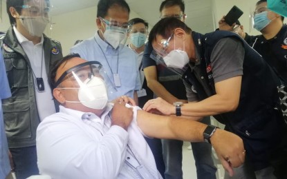 <p><strong>MOCK VACCINATION</strong>. Health Secretary Francisco Duque III does a simulated vaccine injection on Presidential Spokesperson Harry Roque during their visit to a vaccination site inside the Southern Philippines Medical Center (SPMC) in Davao City on Tuesday (Feb. 16, 2021). The Coordinated Operations to Defeat Epidemic or CODE team visited the city to inspect and assess its preparedness for the coronavirus disease 2019 vaccine deployment. <em>(PNA photo by Che Palicte)</em></p>