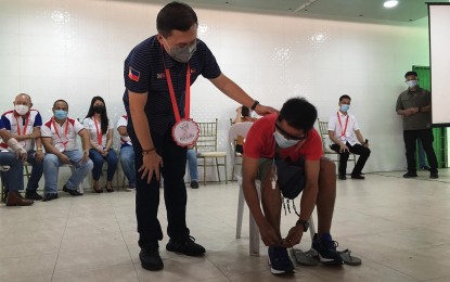 <p><strong>ASSISTANCE</strong>. Senator Christopher Lawrence “Bong” Go gives a pair of shoes to a typhoon victim during his visit in Pulilan, Bulacan on Tuesday (Feb. 23, 2021) to distribute relief assistance. Go personally provided food packs and cash assistance to 431 individuals affected by last year's Typhoon Ulysses.  <em>(Photo by Manny Balbin)</em></p>