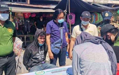 <p><strong>NABBED.</strong> Anti-narcotics agents account for the illegal stuff seized from alias 'Omar' (seated) following his arrest during an anti-drug operation in Dalican, Datu Odin Sinsuat, Maguindanao. An estimated PHP680,000 worth of shabu is seized from the suspect’s possession, authorities say. <em>(Photo courtesy of PDEA-BARMM)</em></p>