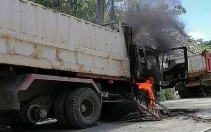 <p><strong>DESTROYED EQUIPMENT</strong>. The communist New People’s Army (NPA) on Feb. 24 burned PHP5.9-million worth of equipment being utilized for the completion of a farm-to-market road project in Barangay Binocaran, Malimono, Surigao del Norte. The damaged dump truck and backhoe are owned by CV Construction based in Surigao City<em>. (Photo courtesy of PRO-13 Information Office)</em></p>