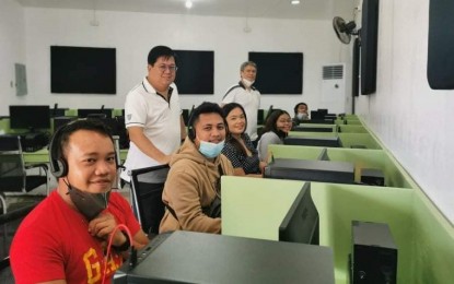 <p><strong>IT FACILITY</strong>. Negros Occidental 2nd District Rep. Leo Rafael Cueva (standing left) and Sagay City Mayor Alfredo Marañon III (right), with the digital workers, during the launching of the city’s first information technology-business process management facility in partnership with Virtual Workforce Professionals on Wednesday (Feb. 24, 2020). “This is a step towards making Sagay the next IT hub in the province’s second district alongside Cadiz City,” Marañon said. <em>(Photo courtesy of Lawyer Jocelle Batapa-Sigue)</em></p>