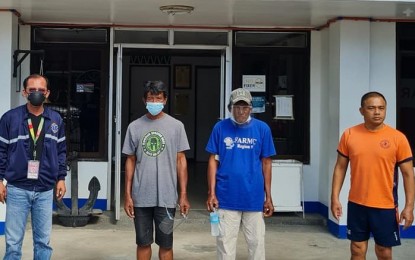 <p><strong>HOMEBOUND</strong>. Sipalay City Executive Assistant Dionilo Bogtae (left) and Commander Jansen Benjamin (right), head of Philippine Coast Guard-Negros Oriental, together with rescued fishermen Alex Alagao (2nd from right) and Rico Norquia, at the Coast Guard Station in Dumaguete City before the two were brought home to Negros Occidental on Thursday (Feb. 25, 2021). The two arrived in Dumaguete on Wednesday night, coming from Zamboanga del Norte, where fellow fishermen in Siocon town assisted them when they were swept ashore on Feb. 22.<em> (Photo courtesy of Dionilo Rodero Bogtae)</em></p>