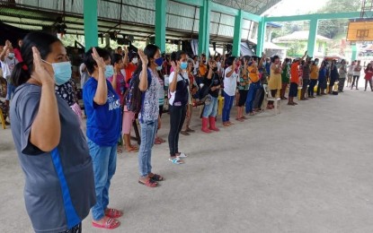 <p><strong>NO TO CTGs</strong>. Residents of Barangay Bagongbong in Lambunao town, Iloilo swear allegiance to the government and denounce the CPP-NPA in this undated photo. Bagongbong is among the 13 barangays in Panay island that declared the CPP-NPA-NDF persona non grata in February 2021. <em>(Photo courtesy of 301st Infantry Brigade, Philippine Army)</em></p>