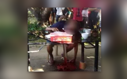 <p><strong>MANHUNT ON.</strong> The body of Mabuhay, Zamboanga Sibugay Vice Mayor Restituto Calonge is slumped on a table after a gunman shot him to death Friday afternoon (Feb. 26, 2021). PNP chief Gen. Debold Sinas on Sunday (Feb. 28, 2021) said a manhunt operation is underway to arrest the killers of Calonge and Edgar Pampanga, an engineer.<em> (Photo courtesy of PRO-9)</em></p>