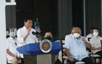 <p><strong>THANK YOU</strong>. President Rodrigo Duterte delivers his message during the ceremonial turnover of the 600,000 doses of China-donated Sinovac vaccines at the Villamor Air Base in Pasay City on Sunday (Feb. 28, 2021). Duterte said he intends to visit China before the end of the year to personally thank Chinese President Xi Jinping for the “CoronaVac” Covid-19 vaccine donation to the Philippines. <em>(PNA photo by Avito Dalan)</em></p>