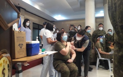 <p><strong>COVID JAB.</strong> Department of Health Secretary Francisco Duque III administers the Covid-19 vaccine to Col. Fatima Claire Navarro, V. Luna Medical Center's commanding officer, on Monday (March 1, 2021). Around 600 doses of China-donated CoronaVac vaccines were allocated to the hospital. <em>(Photo by Priam Nepomuceno)</em></p>