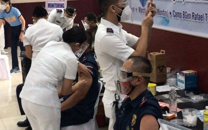 <p><strong>COVID SHOT.</strong> Around 200 medical personnel, including three ranking officials of the Philippine National Police took their first dose of CoronaVac vaccines on Monday (March 1, 2021) at Camp Crame. About 75 percent of the PNP personnel have expressed willingness to get inoculated with the vaccine, PNP deputy chief for administration, Lt. Gen. Guillermo Eleazar said. <em>(Photo by Lloyd Caliwan)</em></p>