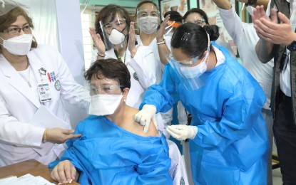 <p><strong>COVID JAB. </strong>Gemma Colcol, nurse supervisor at the Veterans Memorial Medical Center in Quezon City, gets vaccinated with CoronaVac on  March 1, 2021. A total of 193,492 doses of Covid-19 vaccines have been administered so far, mostly to medical front-liners, nationwide, the Department of Health said. <em>(PNA photo by Oliver Marquez) </em></p>