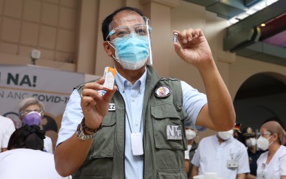<p><strong>VACCINATED.</strong> National Task Force Against Covid-19 chief and vaccine czar Secretary Carlito Galvez Jr. shows the Sinovac vial used for his inoculation on Monday (March 1, 2021) at the Philippine General Hospital. He thanked the Chinese government for the swift arrival of the vaccines. <em>(PNA photo by Joey Razon)</em></p>