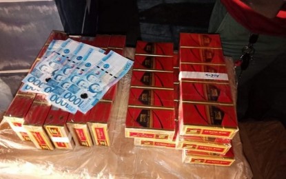 <p><strong>SMUGGLED</strong>. Photo shows the PHP5,000 marked money and the cigarettes under the “Gudang Baru” brand reportedly smuggled from Indonesia that were seized by police operatives during an entrapment Monday night (March 1, 2021) in a house in Barangay Lagao, General Santos City. The illegal cigarettes were being distributed in the area by seven suspects from Zamboanga City. (<em>Photo courtesy of the General Santos City Police Office</em>)  </p>