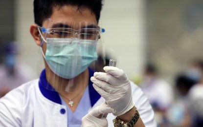 <p><strong>GETTING READY.</strong> A healthcare worker prepares to administer the vaccine during the vaccination program rollout at St. Luke's early this month.<em> </em>Health authorities said vaccines are only one part of the solution in ending the pandemic.<em> (PNA photo by Joey O. Razon)</em></p>