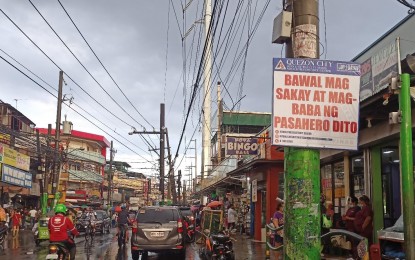 <p><strong>DANGLING WIRES NO MORE.</strong> A portion of Gen. Luis Street in Barangay Novaliches Proper, Quezon City is shown in this photo taken on Feb. 27, 2021. Meralco has begun removing old posts and dangling wires by installing taller concrete posts (colored white at right). <em>(Photo contributed by Christelle S. Reyes)</em></p>