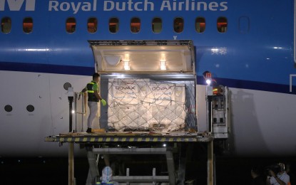 <p><strong>COVAX VACCINES.</strong> Cargoes containing the 487,200 doses of AstraZeneca vaccine are being unloaded from a KLM Royal Dutch Airlines aircraft that arrived at Villamor Air Base in Pasay City on Thursday night (March 4, 2021). It marked the first delivery of the life-saving shots against Covid-19 through COVAX Facility and the second batch after the China-donated 600,000 doses of Sinovac vaccines that arrived on Feb. 28. <em>(PNA photo by Joey Razon)</em></p>