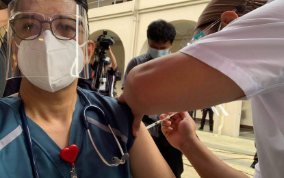 <p><strong>VACCINATION.</strong> Dr. Nemencio Nicodemus Jr., a 51-year-old endocrinologist at the Philippine General Hospital, receives a shot of Sinovac's CoronaVac vaccine at the PGH Atrium on Monday (March 1, 2021). He urged more health care workers to sign up for the nationwide vaccination campaign. <em>(Contributed photo)</em></p>