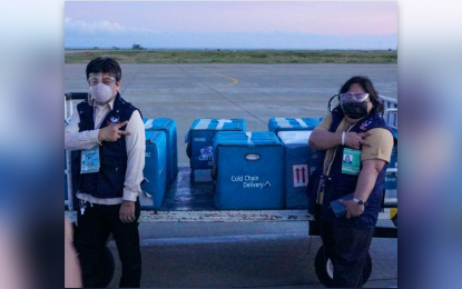 <p><strong>VACCINES FOR MEDICAL WORKERS.</strong> Officials of the Department of Health in Region 10 receive the Sinovac Covid-19 vaccines on Thursday at the tarmac of Laguindingan Airport in Misamis Oriental. Northern Mindanao region has initially been allocated 17,400 doses of the vaccines donated by the Chinese government. <em>(Photo courtesy of PCOO-OGMA)</em></p>