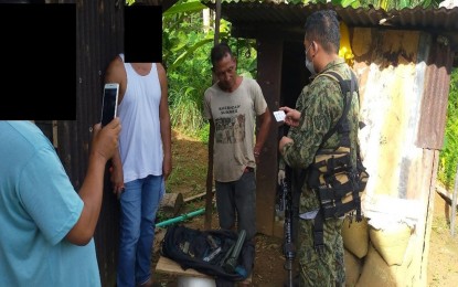 <p><strong>REBEL MILITIA NABBED.</strong> Personnel from Tagana-an Municipal Police Station in Surigao del Norte arrest Danilo Casaquet (2nd from right), an alleged Militia ng Bayan under Guerrilla Front 16 of the New People’s Army on Thursday (March 4, 2021). Seized from the suspect were one M76 rifle grenade and one silver STI EDGE .45 caliber pistol with magazine and five ammunition. <em>(Photo courtesy of PRO-13 Information Office)</em></p>