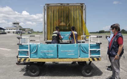 <p><strong>VACCINES FOR CARAGA.</strong> DOH-13 director Jose R. Llacuna Jr. (right) personally supervises the unloading of the 9,000 doses of Sinovac vaccines that arrive at the Bancasi Airport in Butuan City on Friday (March 5, 2021). The vaccines are allocated for some 4,500 health workers in the region. <em>(Photo courtesy of PIA-Caraga)</em></p>