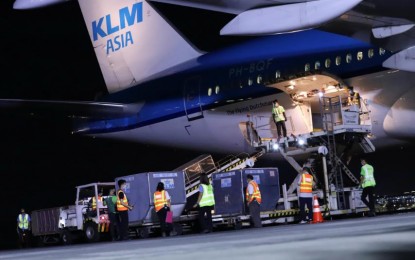 <p><strong>VACCINE ARRIVAL. </strong>Boxes containing vials of AstraZeneca vaccines are offloaded from KLM Asia that flew in from Amsterdam on Sunday night (March 7, 2021). The 38,400 doses are part of 525,600 secured through the COVAX Facility. <em>(PNA photo by Robert Alfiler)</em></p>