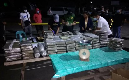 <p><strong>MARIJUANA BRICKS.</strong> Police operatives examine 125 bricks and four tubular packs of marijuana worth PHP16 million seized in a drug buy-bust operation in Quezon, Isabela on Saturday night (March 6, 2021). Two drug dealers were also arrested. <em>(Photo courtesy of PNP PIO)</em></p>