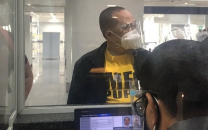 <p><strong>WANTED.</strong> Former police officer Ruben Baliong arrives at the Ninoy Aquino International Airport from Abu Dhabi on Monday (March 8, 2021). Baliong has pending warrants of arrest for murder and physical injuries. <em>(Photo courtesy of PNP-IMEG)</em></p>