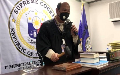 <p><strong>'COURT IN SESSION'</strong>. Acting Presiding Judge Chalmer Gevieso bangs the gavel to signal the formal reopening on Monday (March 8, 2021) of the 1st Municipal Circuit Trial Court in Malapatan town, Sarangani province. The Supreme Court issued the go-signal early this year for the resumption of court’s operations based on a request from the municipal government and other stakeholders.(<em>Photo courtesy of the municipal government</em>)  </p>