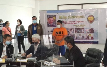<p><strong>SCAMMER.</strong> National Bureau of Investigation officials present on Thursday (March 11, 2021) an extortion suspect who fooled victims by saying he was connected with the office of Senator Bong Go. Suspect John Garcia allegedly collected PHP6 million from his victims who were offered various projects. <em>(Photo courtesy of NBI Facebook)</em></p>