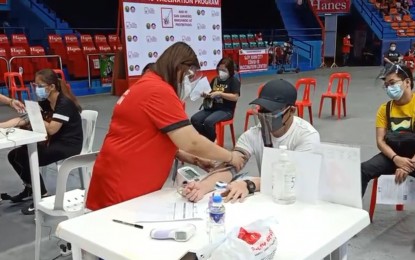 <p><strong>COVID JAB.</strong> A man receives his first dose of AstraZeneca vaccine in San Juan City. This month, the vaccine's use was allowed to continue for all ages eligible -- 18 years old and above -- since the benefits of receiving it outweigh the risk according to experts. <em>(File photo)</em></p>