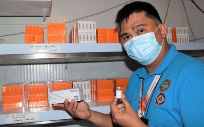 <p><strong>MORE VACCINES</strong>. Zeaphard Caelian, head of the Provincial Disaster Management Program Division and commander of the Provincial Incident Management Team for Covid-19, shows the AstraZeneca vaccines stored inside the cold room of the Negros Occidental Provincial Health Office. The Department of Health-Western Visayas dispatched on Friday (March 12, 2021) an initial supply of 74 vials for Negros Occidental and 312 vials for Bacolod City. <em>(Photo courtesy of PIO Negros Occidental)</em></p>