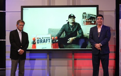 <p><strong>FIRST PICK.</strong> Terrafirma governor Bobby Rosales (left) and PBA commissioner Willie Marcial take a photo together with top pick Joshua Munzon on the TV screen during the first virtual draft on Sunday (March 14, 2021). Including the Gilas picks, 65 players were drafted, setting the new record for the most players selected in a single draft. <em>(Photo courtesy of PBA Images)</em></p>