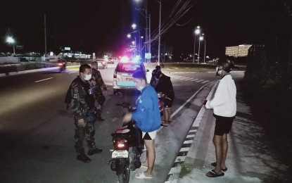 <p><strong>CHECKPOINT.</strong> Even before curfew hours were reimposed, the Pasay City police were already strict on violators of local ordinances. In this February 5 photo, the community police near the Cultural Center of the Philippines made sure the motorcycle rider was carrying proper credentials.<em> (Photo courtesy of CCPComplex PCP Pasay)</em></p>