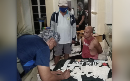 <p><strong>ARRESTED.</strong> An undercover policeman conducts an inventory on the pieces of evidence seized from Rithar Abdulkarim, 38, an alleged high-value target (HVT) in Zamboanga City. The Police Regional Office-9 says it focuses on HVTs as they are the main source of illegal drugs in the region. <em>(Photo courtesy of PRO-9 Public Information Office)</em></p>